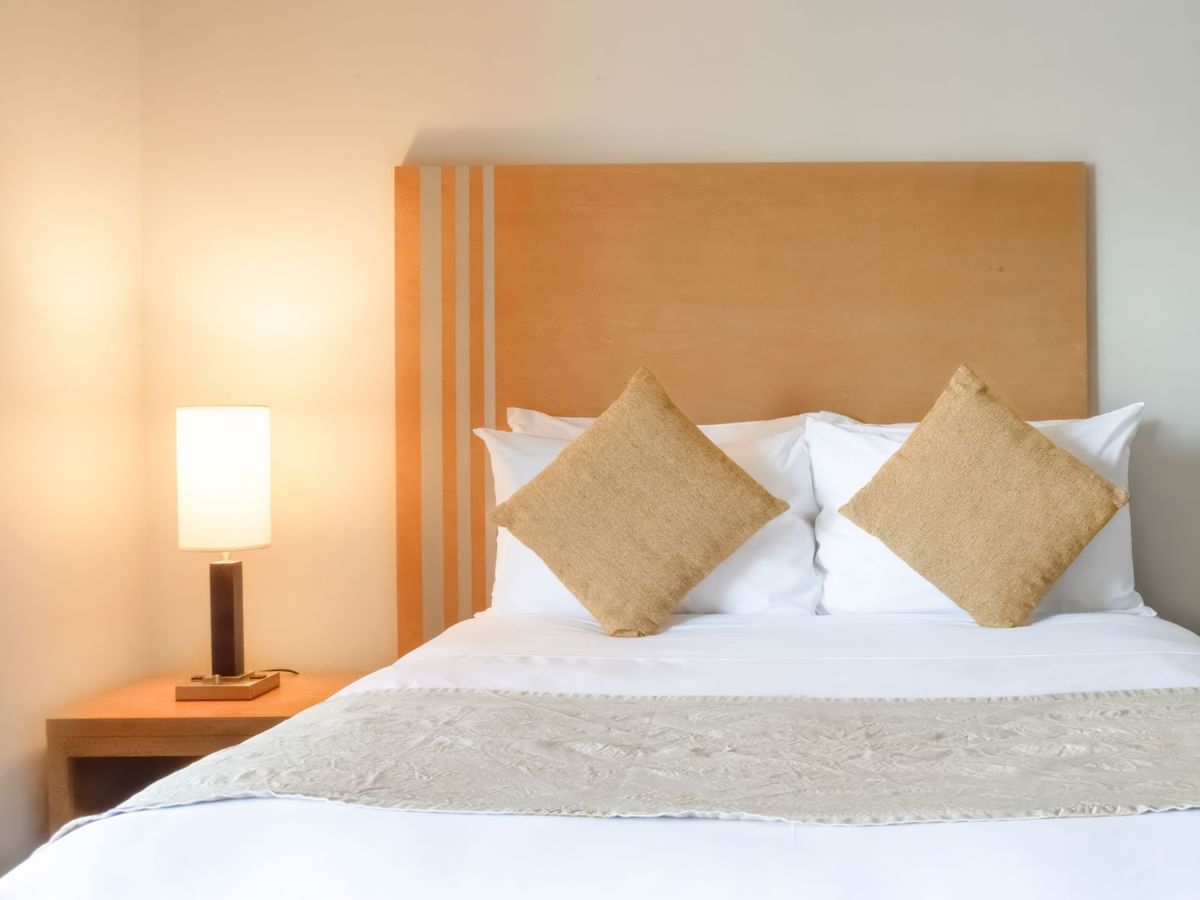 Bed with lamp on a side table