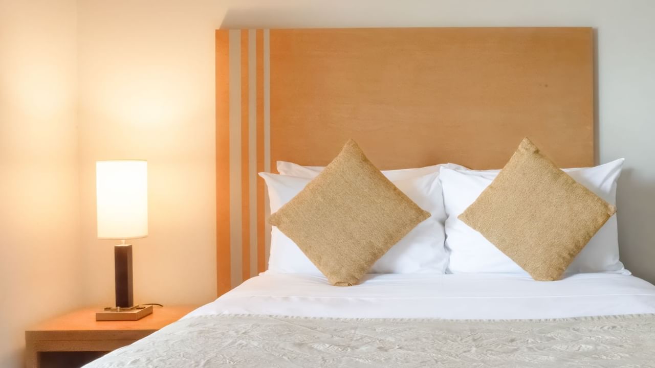 Bed with lamp on a side table