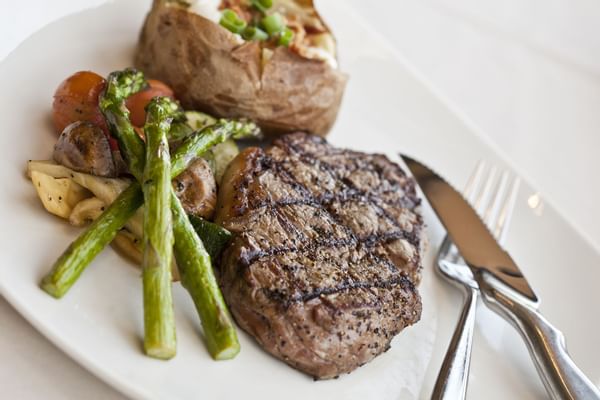 steak with baked potato and asparagus