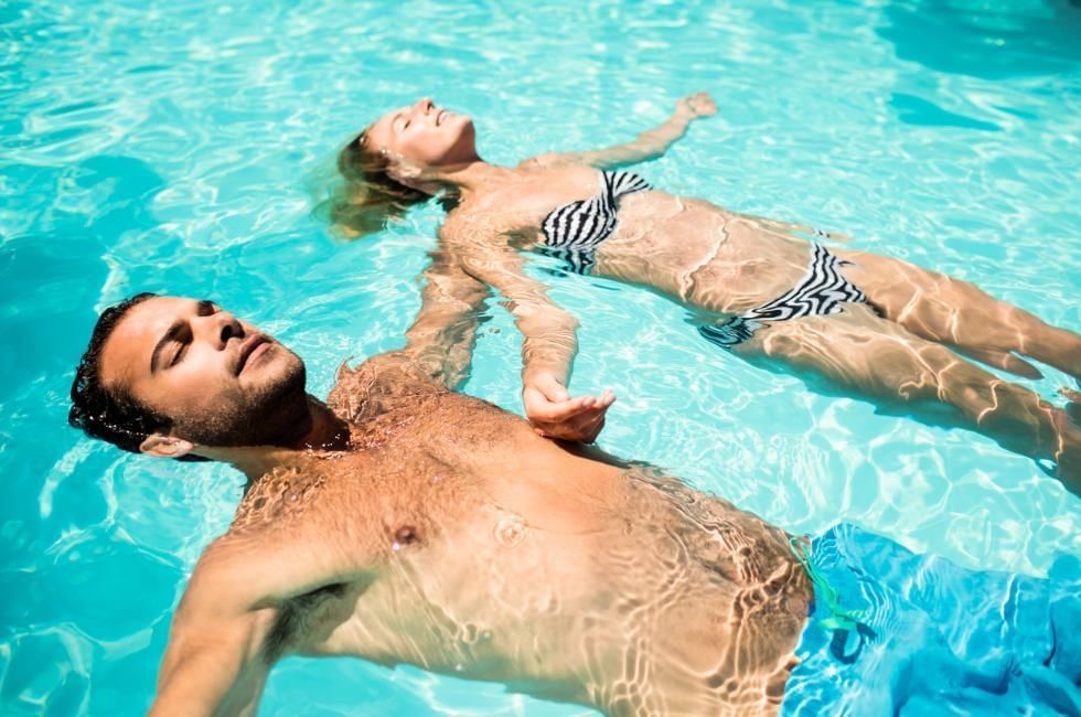 couple relaxing in pool on holiday