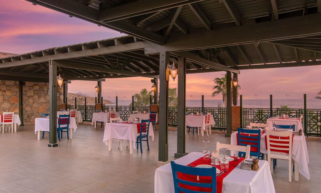 Bodrum Imperial'deki Olive Restaurant'ta yemek alanı ve deniz manzarası