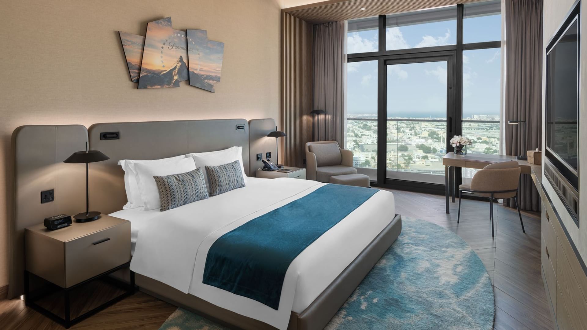 Workspace and cozy seating area by the bed in Scene Room with a city view at Paramount Hotel Midtown