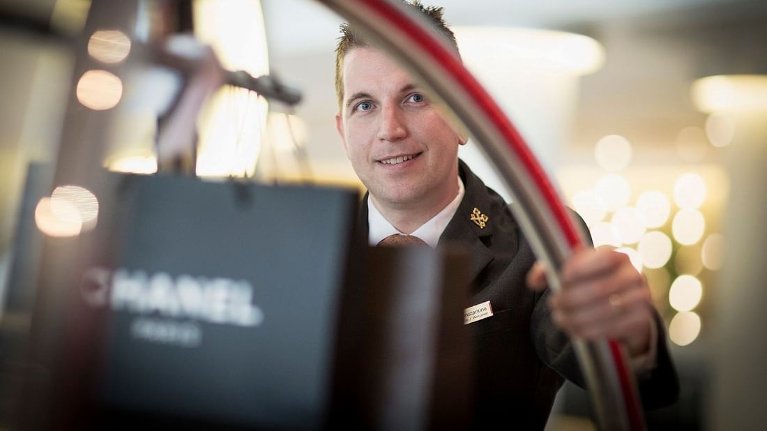 Close-up of a staff member carrying a luggage trolley at Pullman Albert Park
