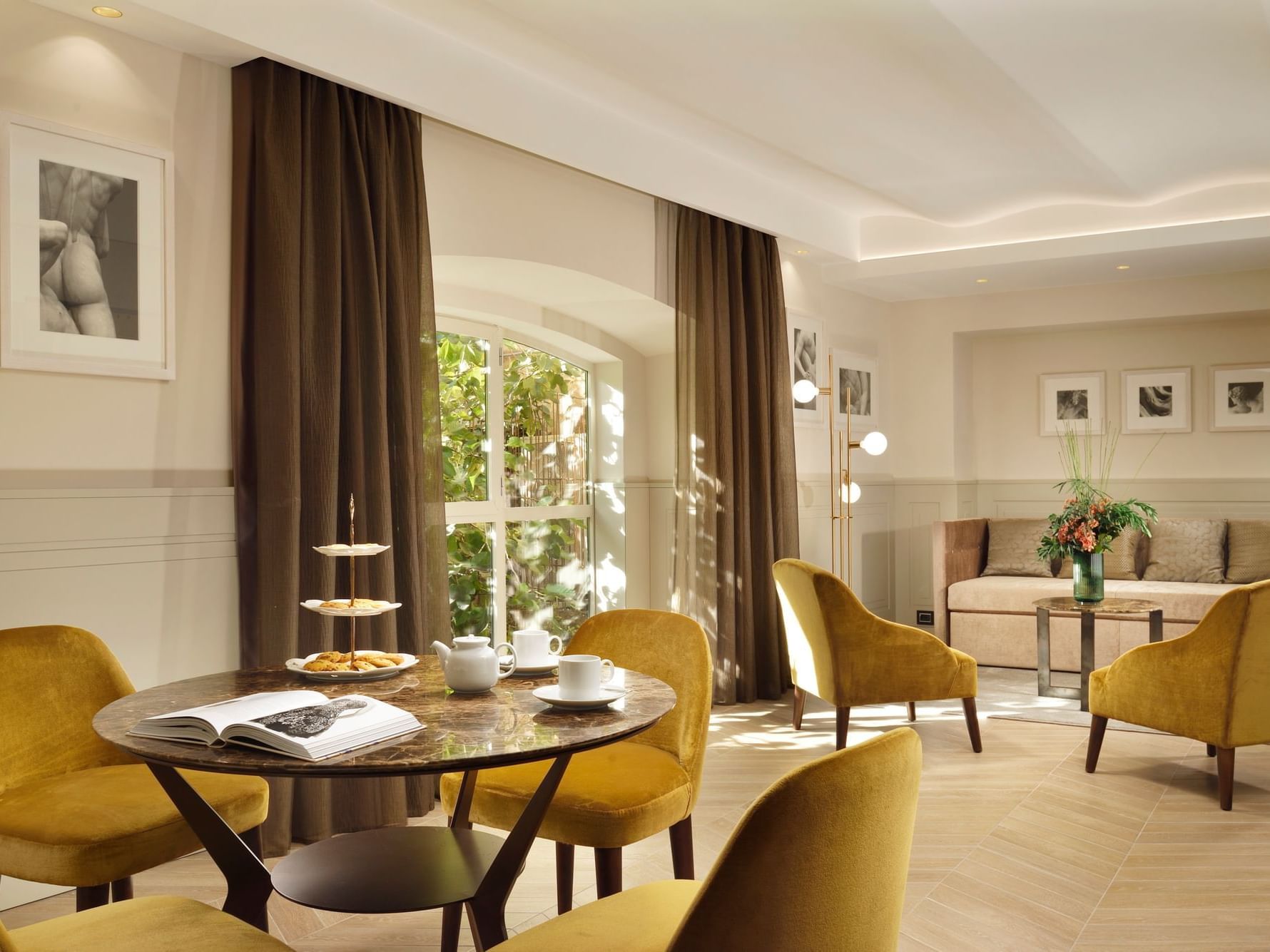 Dining table and cozy loungers arranged in living area of Studio Suite at Margutta 54