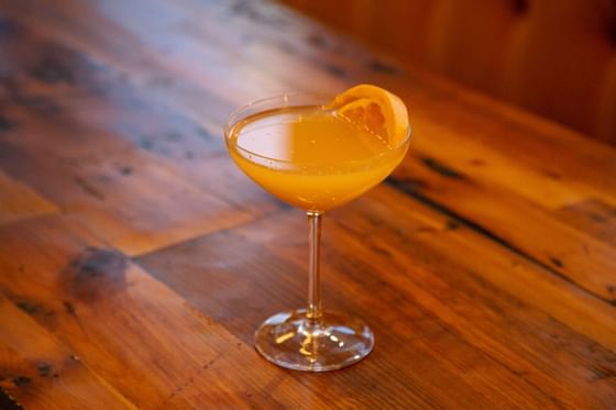 a cocktail with an orange slice
