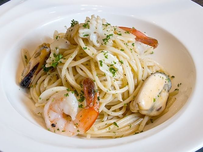 Close-up on a delicious sea food pasta plate at Chatrium Hotel