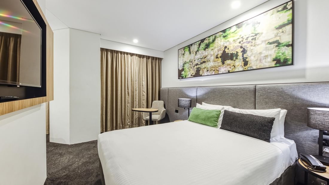 Modern Superior Family Room with white bedding, artwork, and chair at Mercure Penrith, Penrith.