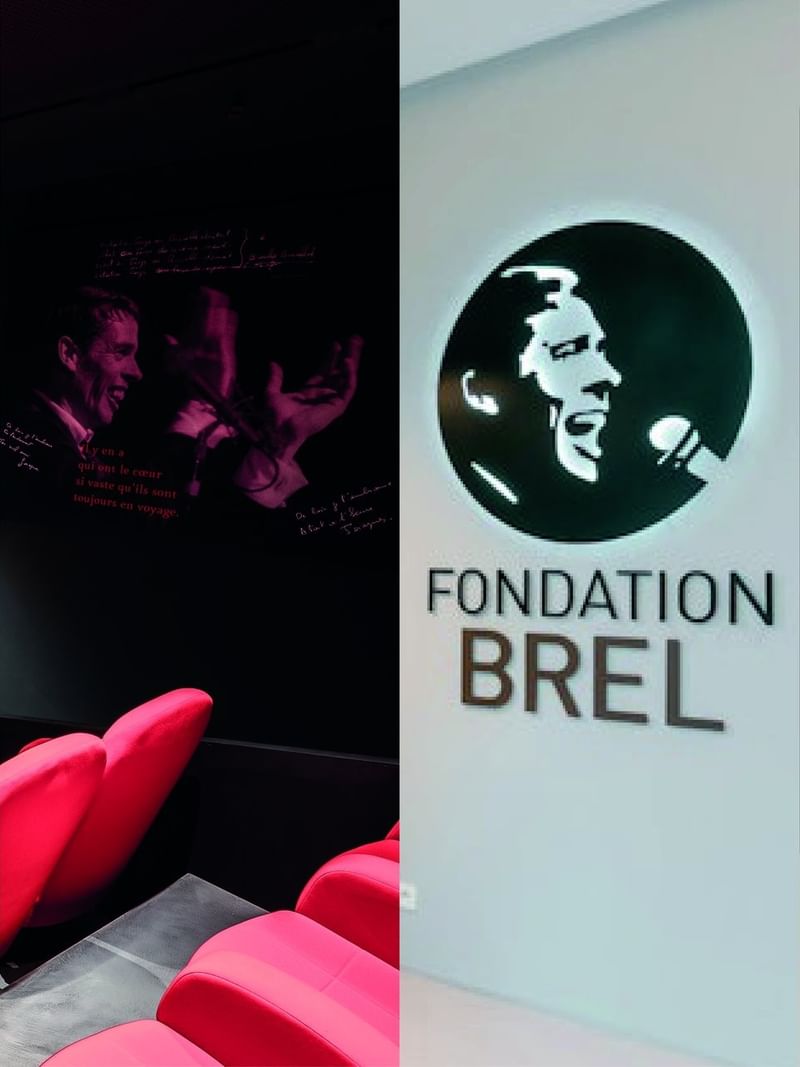 Fondatio Brel interior with red chairs in a cinema area by a lounge space near Warwick Grand Place Brussels