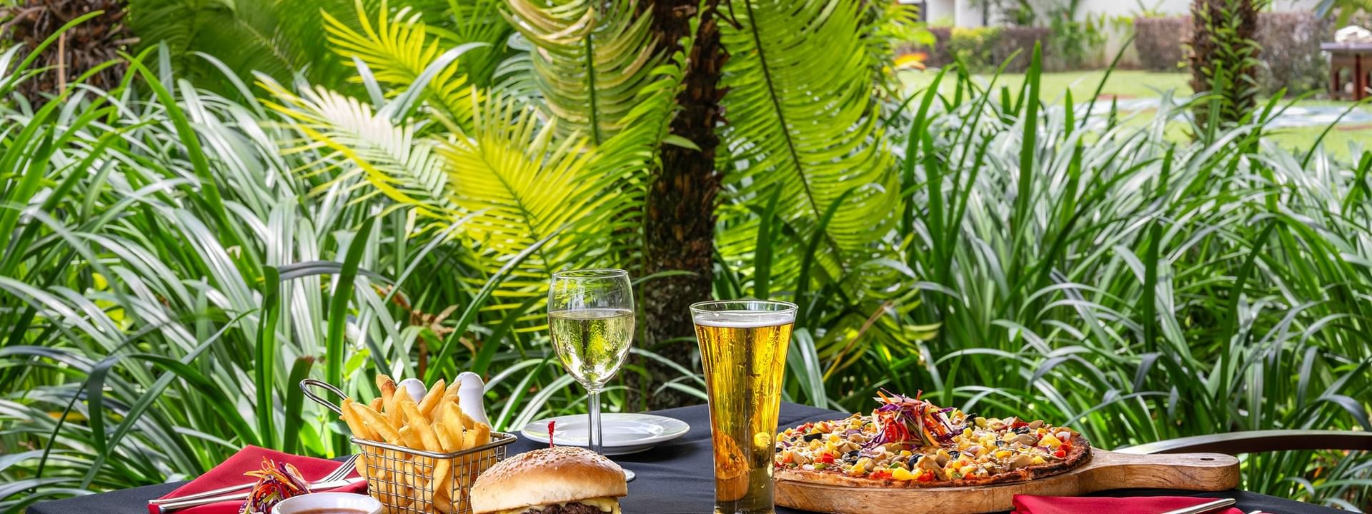 Outdoor table with food and drinks at The Naviti Resort Grill in Korolevu.