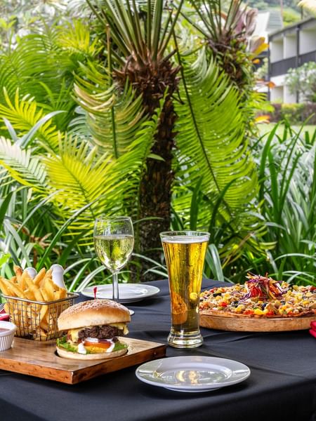 Outdoor table with food and drinks at The Naviti Resort Grill in Korolevu.