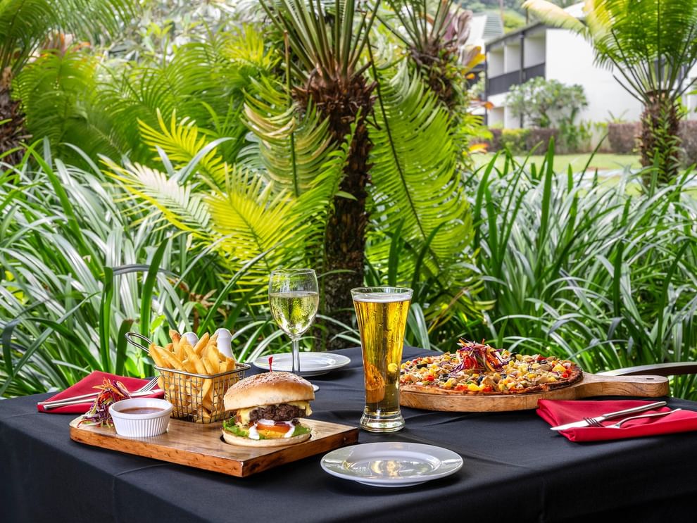 Outdoor table with food and drinks at The Naviti Resort Grill in Korolevu.
