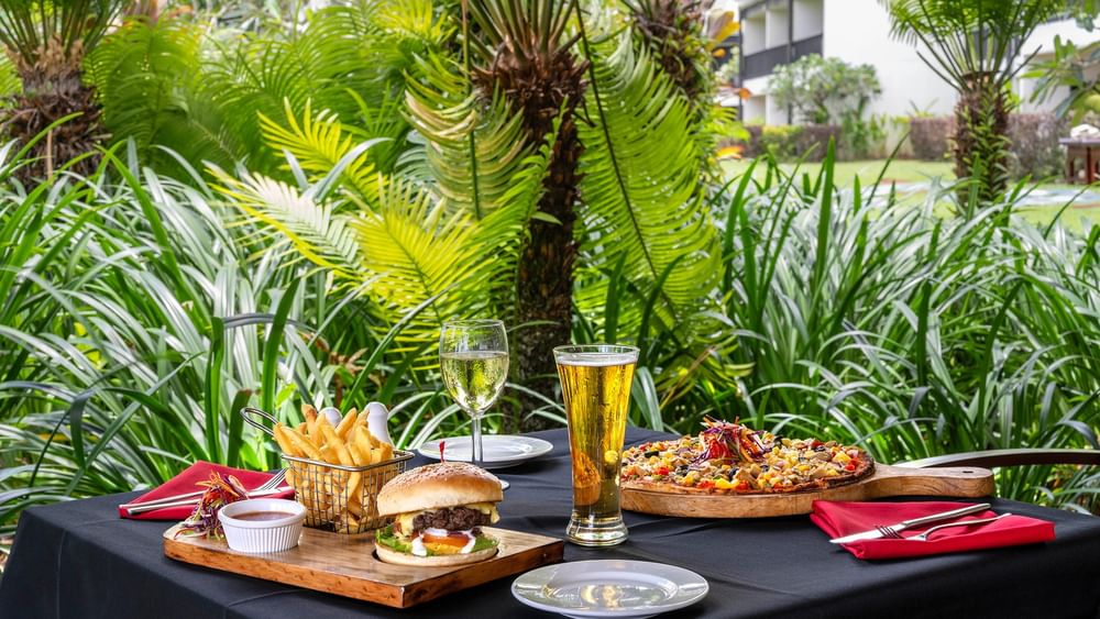 Outdoor table with food and drinks at The Naviti Resort Grill in Korolevu.