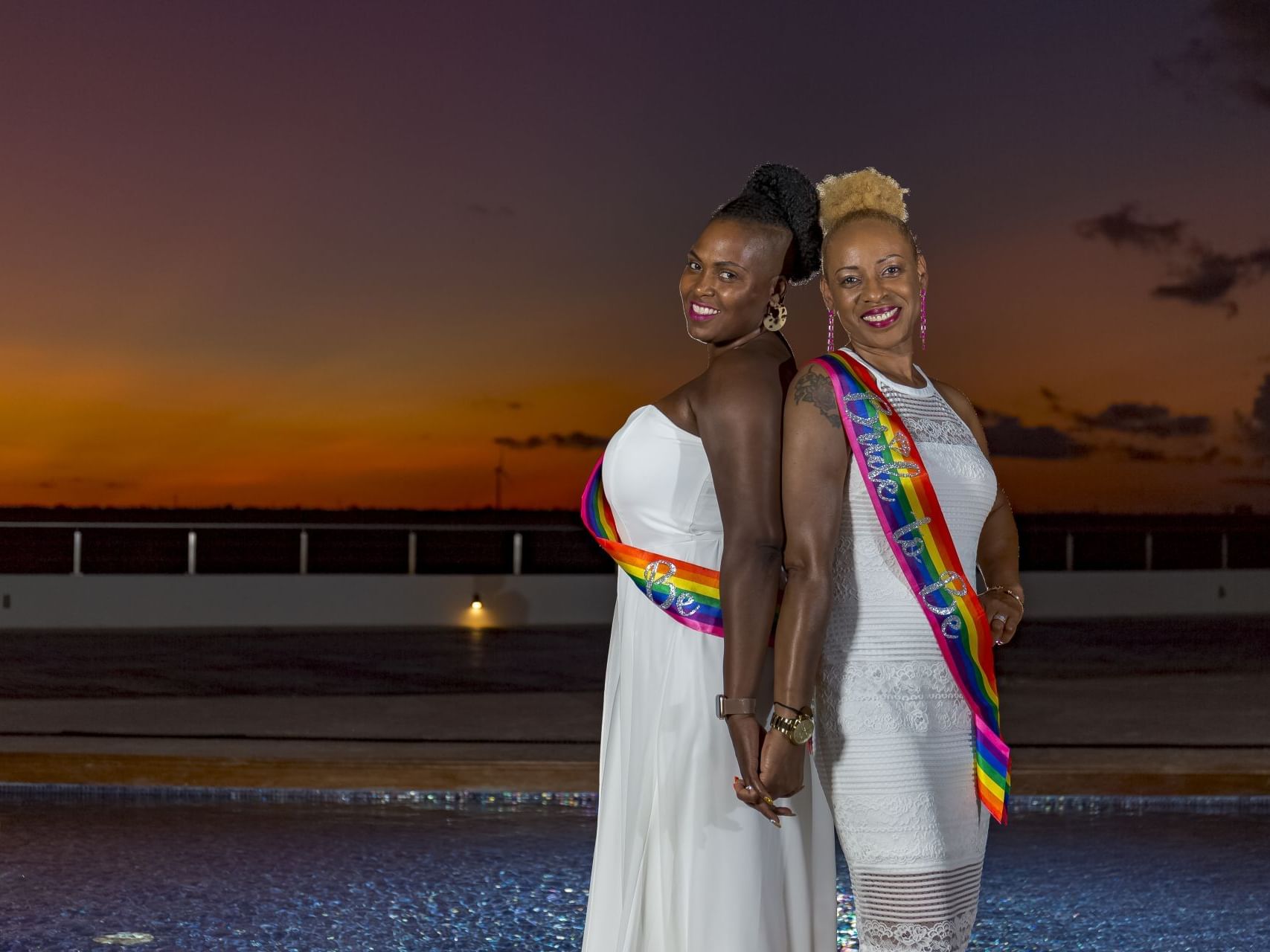 Wedded couple posing by the pool during sunset at Haven Riviera Cancun