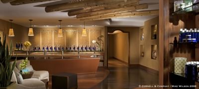 Serene Wo'P'in Spa reception at Hilton Santa Fe Buffalo Thunder with natural wood beams and product displays