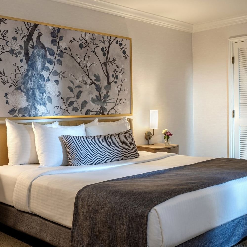 King room with a large bed, artwork, and side tables at Warwick Allerton - Chicago in Chicago.