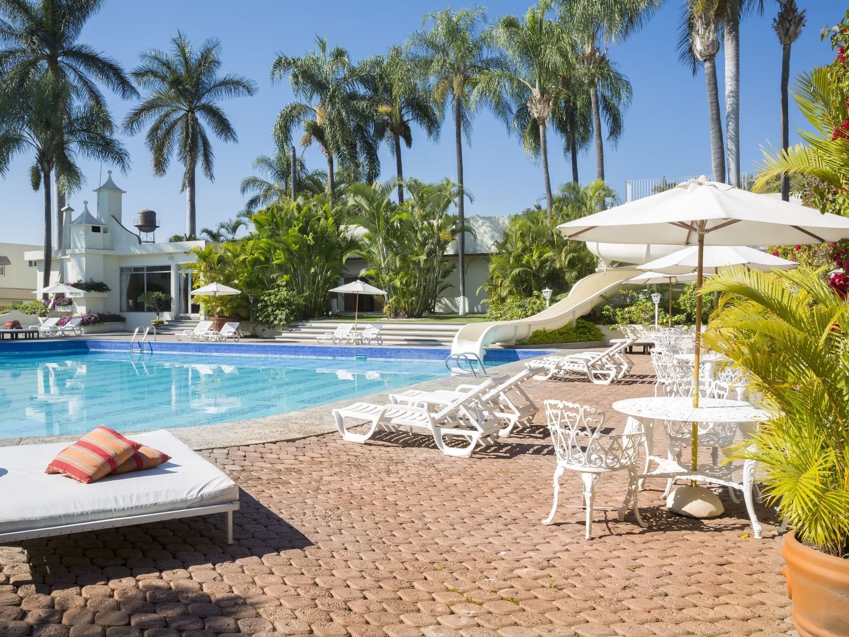 Sunbeds & canopies by the outdoor pool at Gamma Hotels