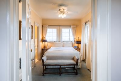 King bed with ottoman in The Garden Porch, one of the hotel rooms Catalina Island at Mt Ada