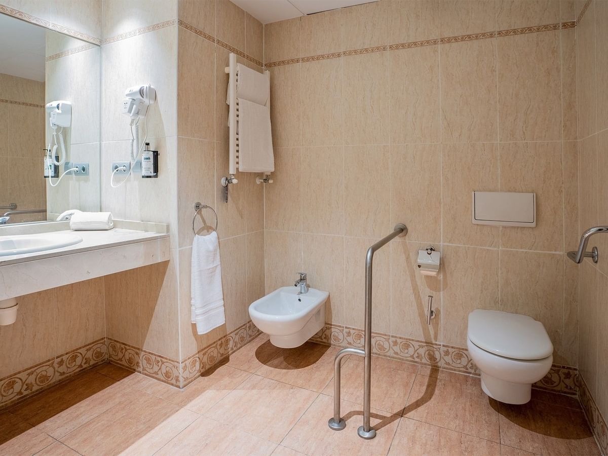 Adapted Standard Rooms bathroom featuring a bathtub, and a mounted showerhead at Ponient Pirámide Salou