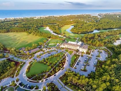 Aerial view of Fairway Park surrounded by lush golf course and coastal landscape at Camp Creek Inn in Inlet Beach