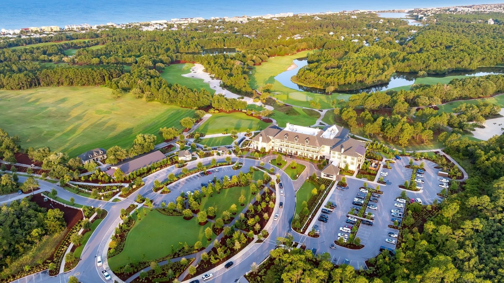 Aerial view of Fairway Park surrounded by lush golf course and coastal landscape at Camp Creek Inn in Inlet Beach