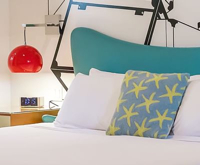 Image showing king size bed, and bedside tables with bright red lamps above