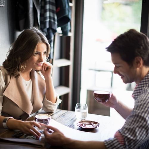 Couple having coffee at Chapel Street near The Como Melbourne