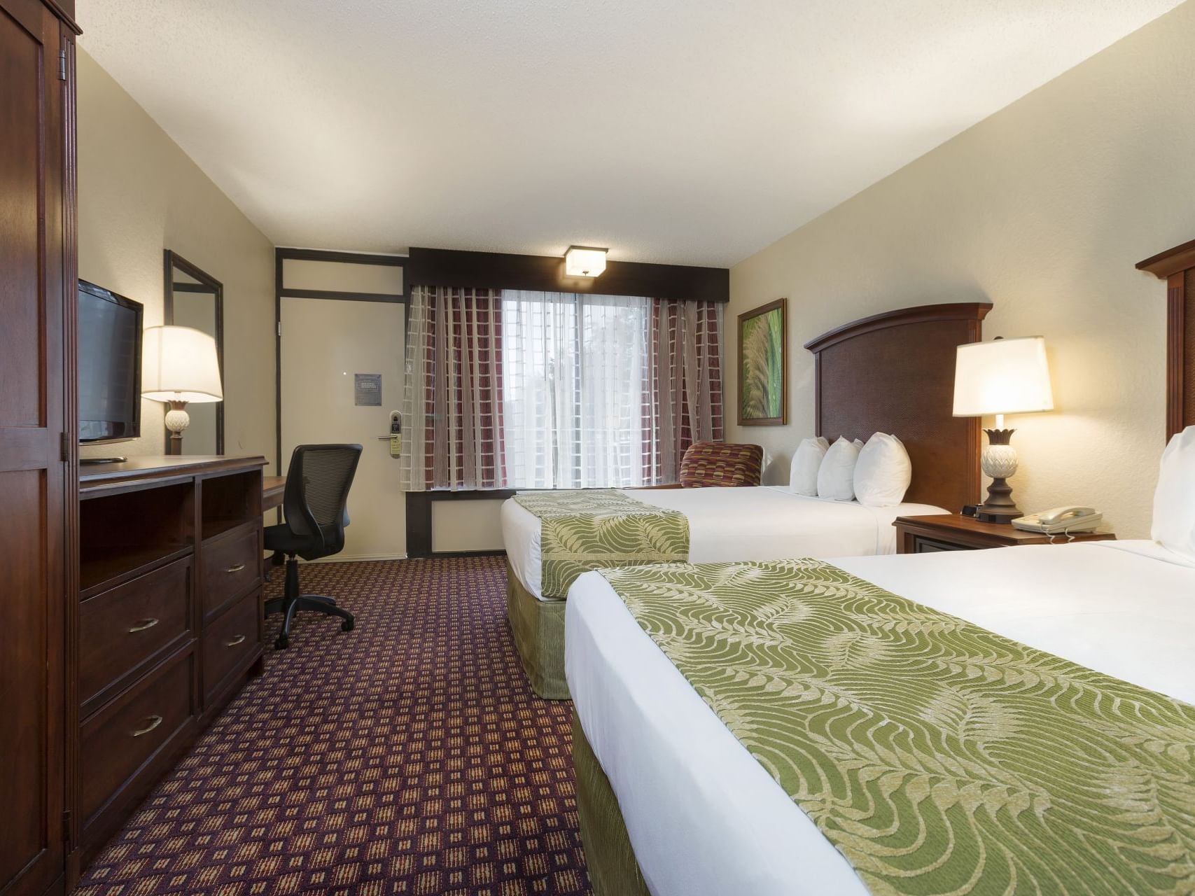 Twin beds & TV in Deluxe Double Room at Rosen Inn International