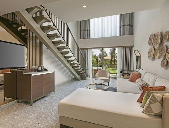 Living room with TV, staircase and view of the outdoors in Family Duplex at Cullinan Belek