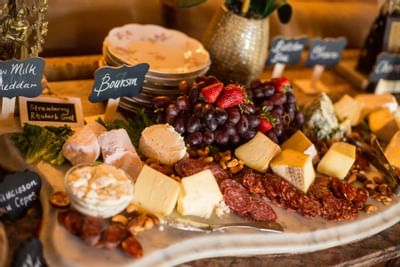 Close-up of cheese & fruits on a buffet at The Inn at Saratoga