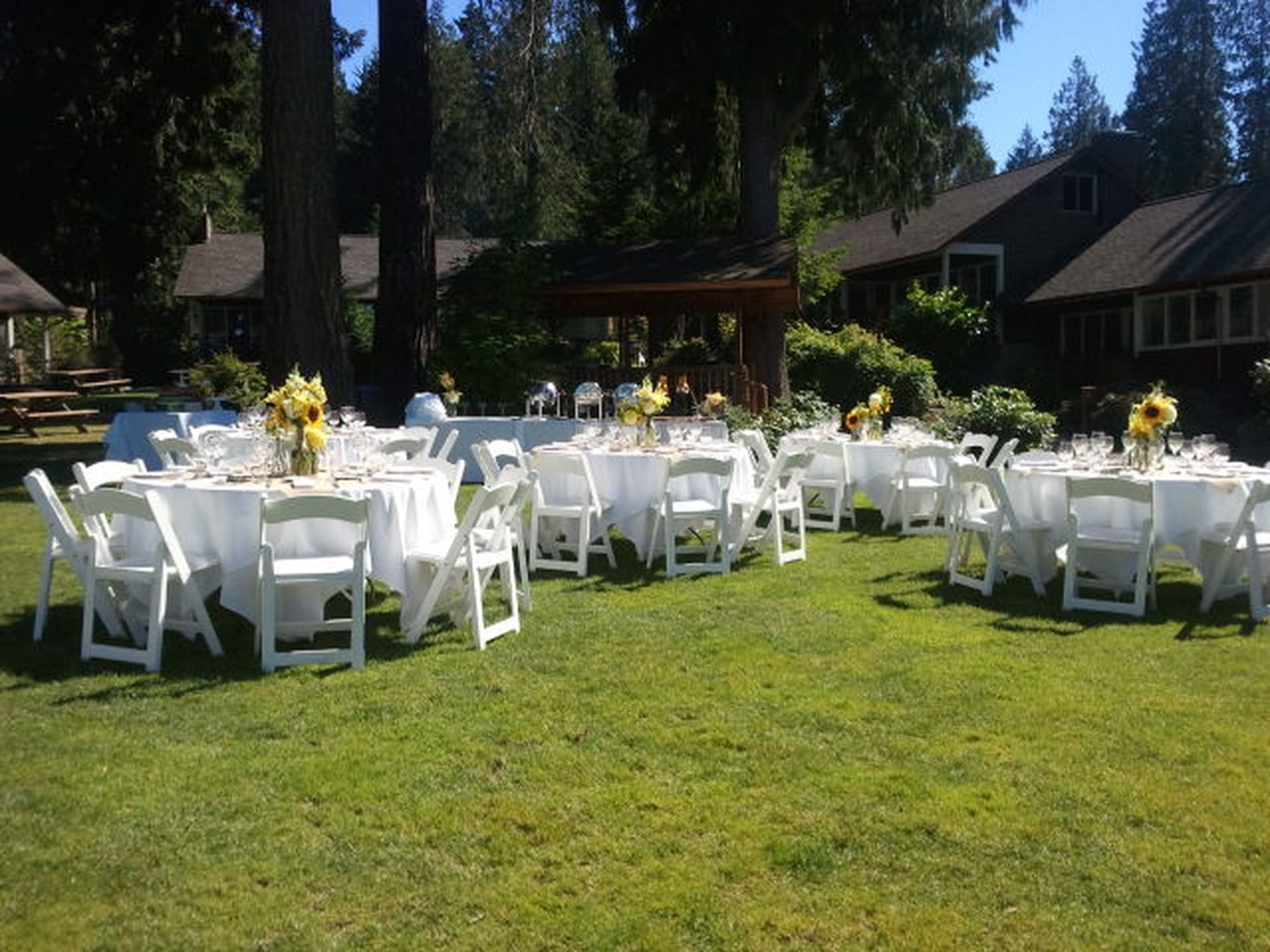Banquet table set-up for a wedding event arranged outdoors on Cottage Lawn at Alderbrook Resort & Spa