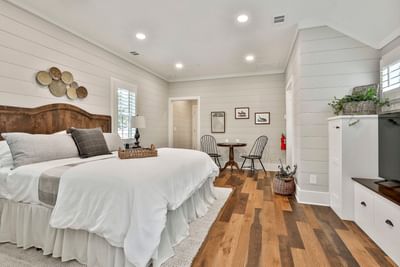 Stylish Deluxe King Cottage with a cozy bed, dining table, TV unit, and neutral decor by Cottages at Laurel Brooke