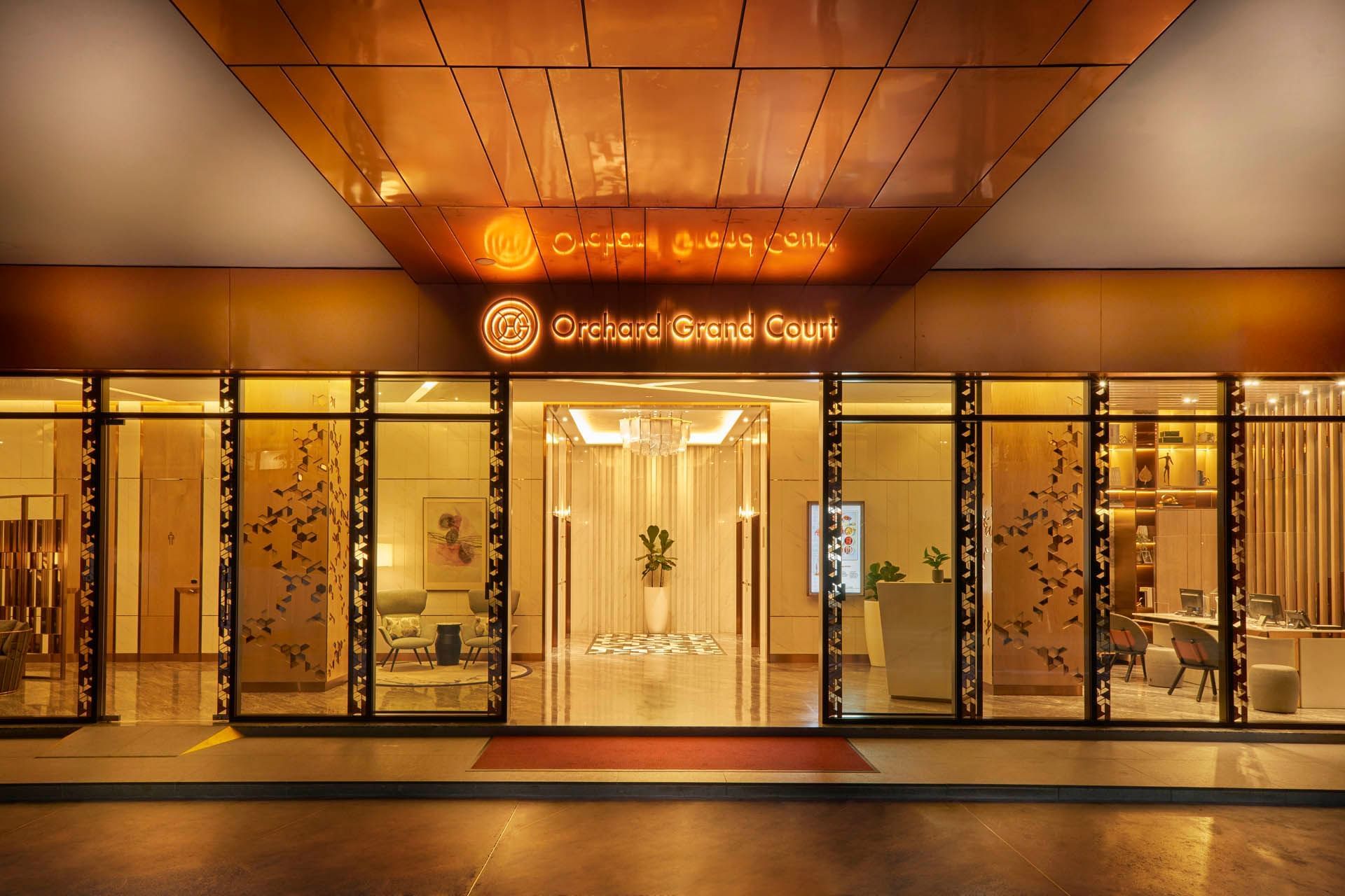 Image 3: Elegant exterior view of the lobby entrance with the hotel sign at Orchard Grand Court