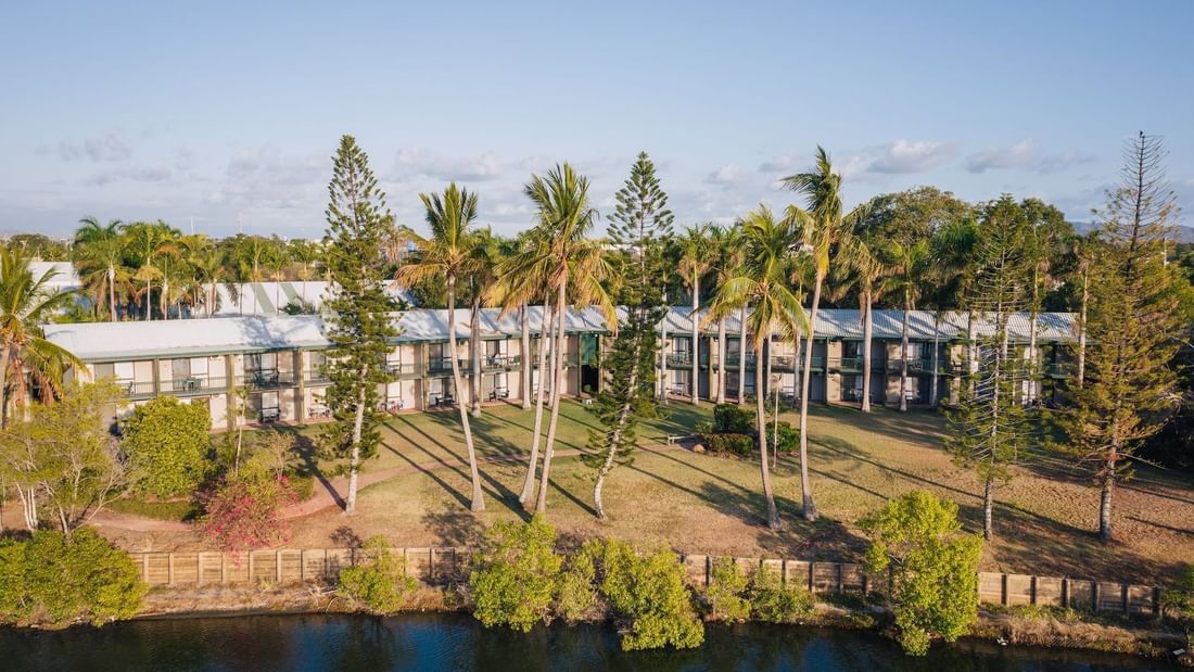 Aerial view of Mercure Hotel Townsville surrounded by palm trees, lush greenery