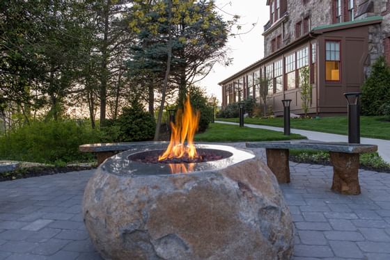 Firepit carved in a rock in the garden at The Abbey Inn