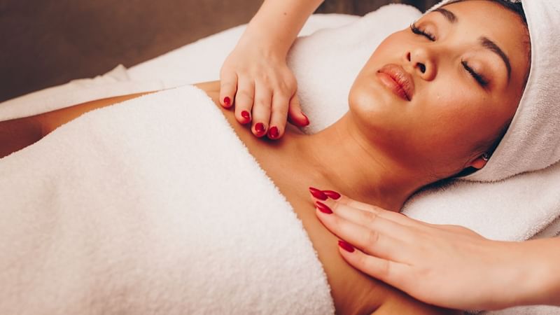 Woman receiving a relaxing body massage in a spa at The Londoner Hotel