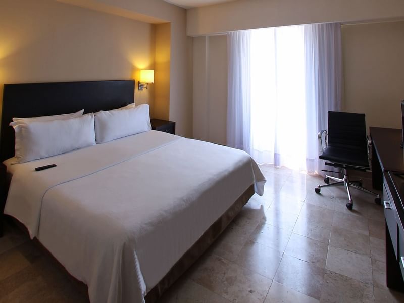 King bed with working desk in Superior Room at Fiesta Inn