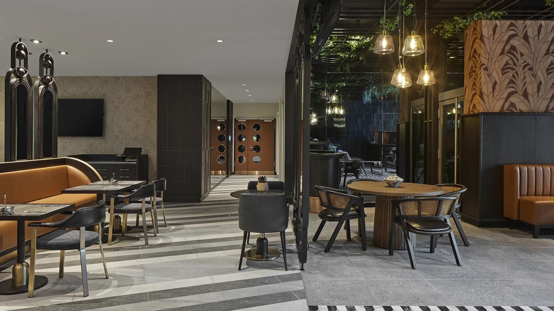 Cafe interior with plush seating and ornaments in Winter Garden at Titanic Comfort Kurfürstendamm