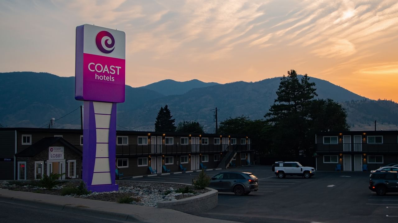 Exterior of Coast Penticton Hotel with a Coast Hotels sign during sunset