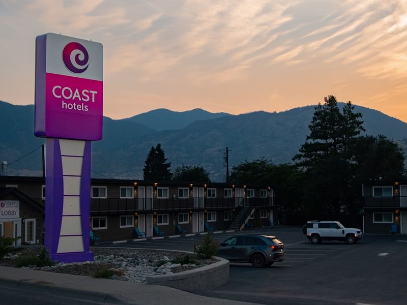 Exterior of Coast Penticton Hotel with a Coast Hotels sign during sunset