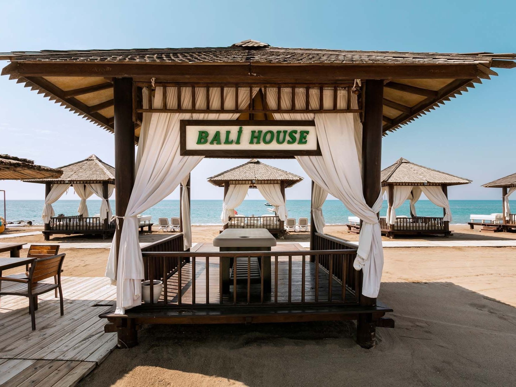 Beach cabanas with white curtains and 