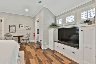 Modern Deluxe King Cottage with a cozy bed, dining table, TV unit, and neutral decor by Cottages at Laurel Brooke
