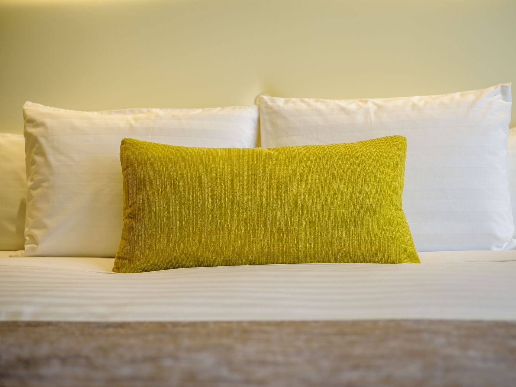 Closeup on some pillows in a bedroom at Ritz Apart Hotel