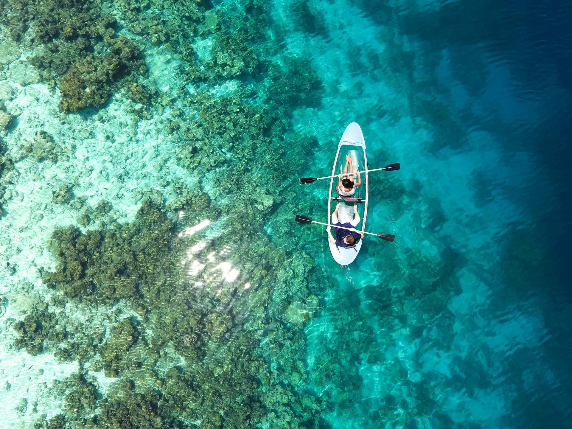 Aerial view of a couple on a clear kayak near Ananea Madivaru Maldives