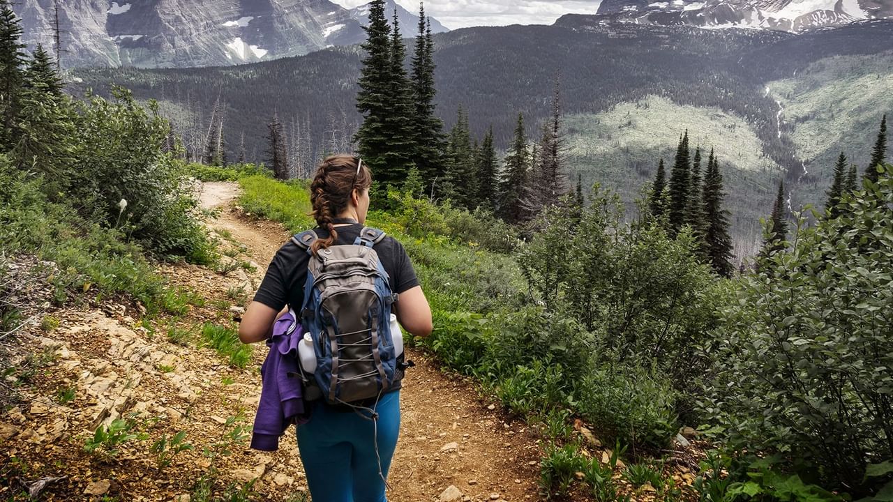 Girl hiking with a backpack full of gear, Coast Hinton Hotel