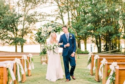 bride and groom posing in aisle