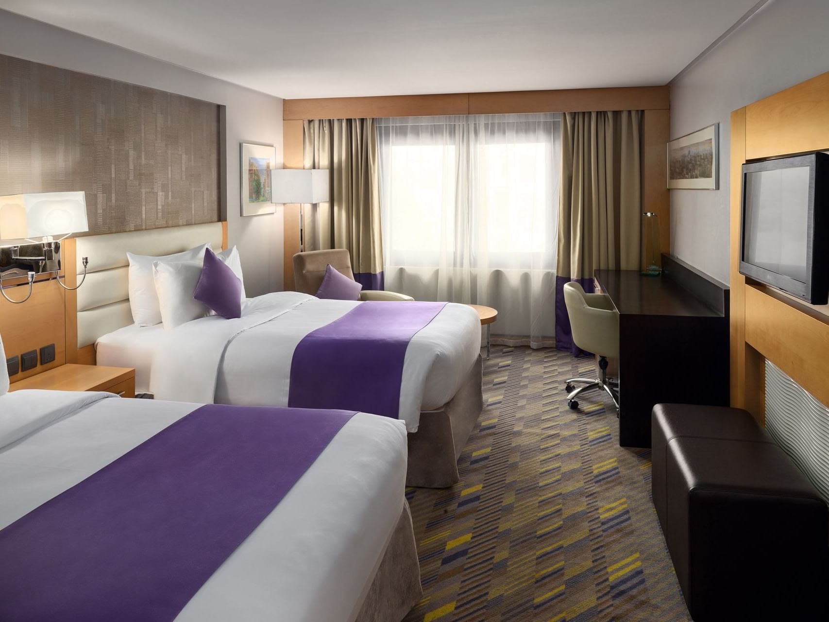 TV & 2 beds in Deluxe twin Suite at Mena Plaza Hotel