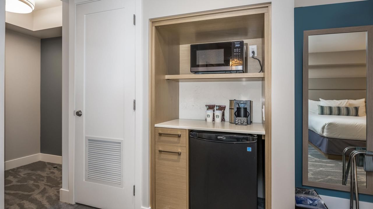 View of kitchenette with microwave, coffee maker and mini fridge in our Coast Acessible Two Queens Bedroom