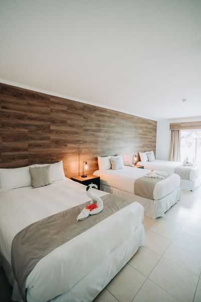 Interior of the room with three beds in Playa Blanca Beach Resort