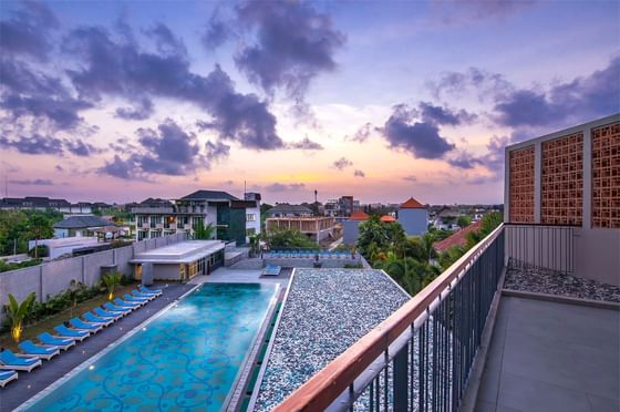 Outdoor pool & city view from balcony at Eastin Ashta Resort Canggu