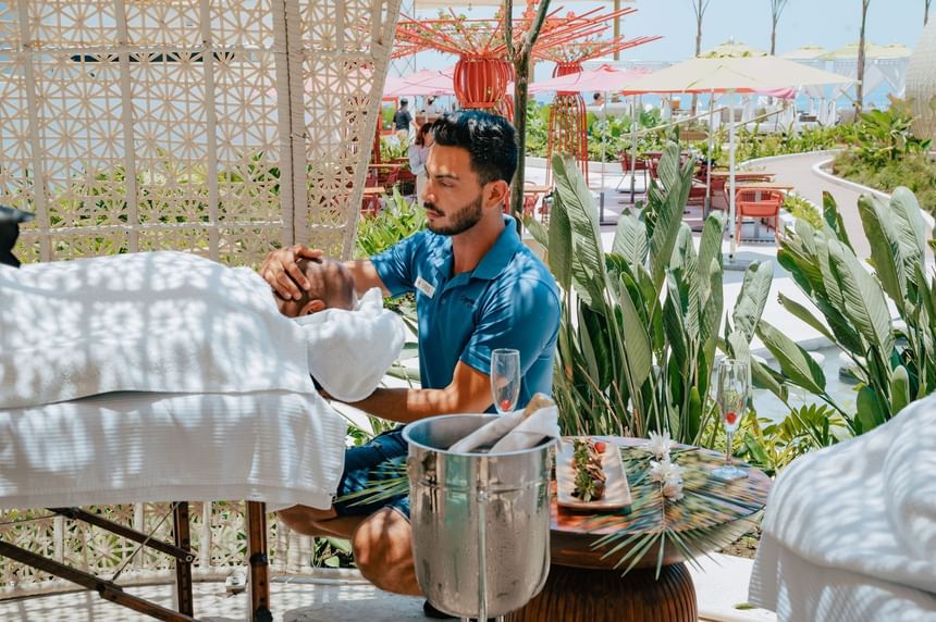 Man enjoying a relaxing massage inside a cabana at Almar Beach Resort